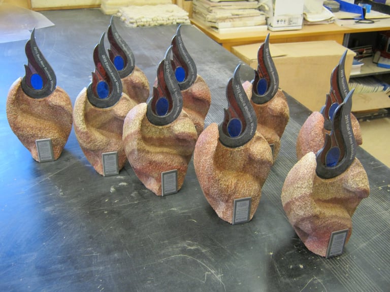 Collection of decorative sculpture pieces with cork-textured bases and blue flame-like tops arranged on a table